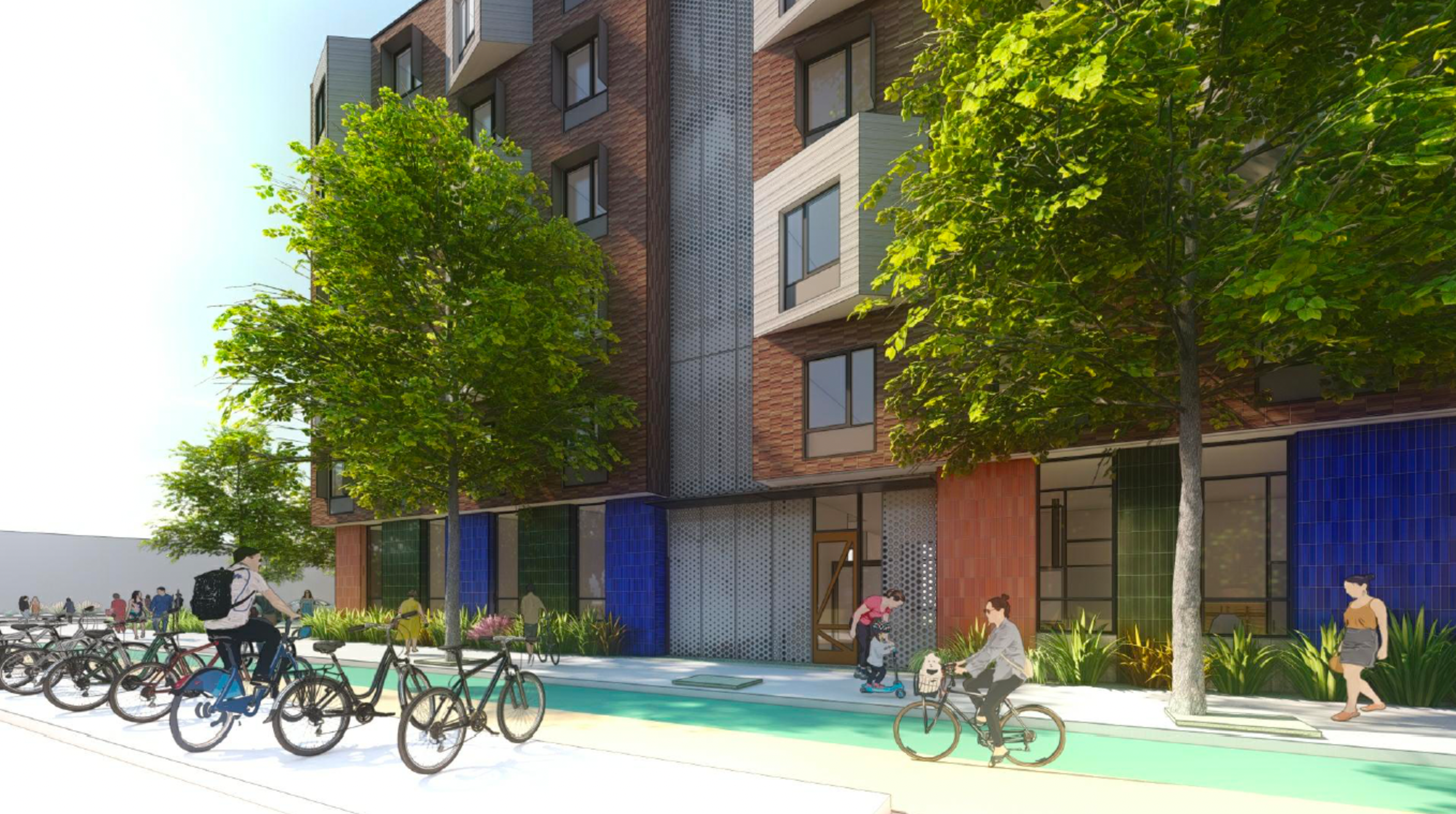 A modern brick building with large windows faces a tree-lined street where people ride bikes, walk, and a child scoots near colorful tiled walls.