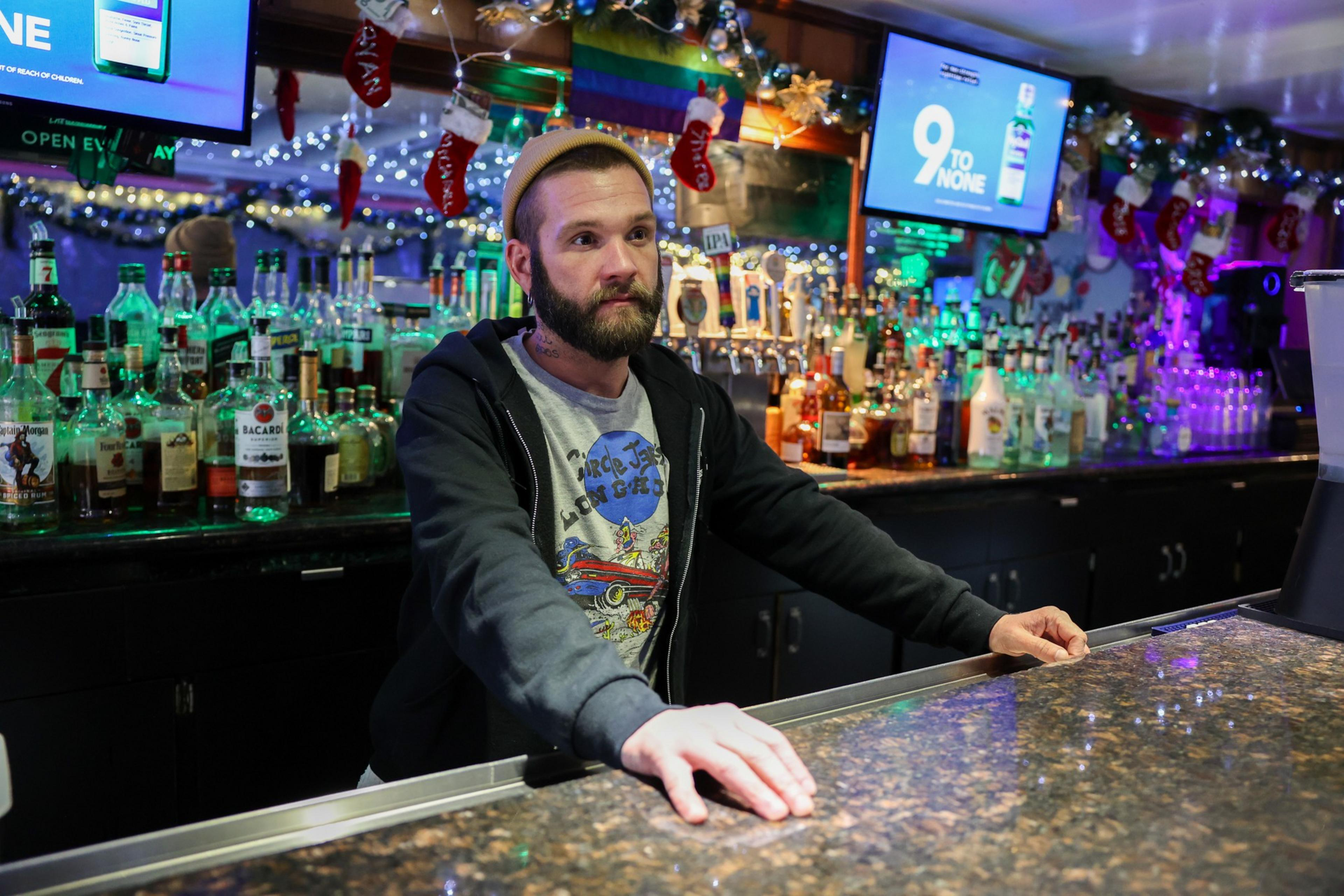 A bartender stands behind the bar.