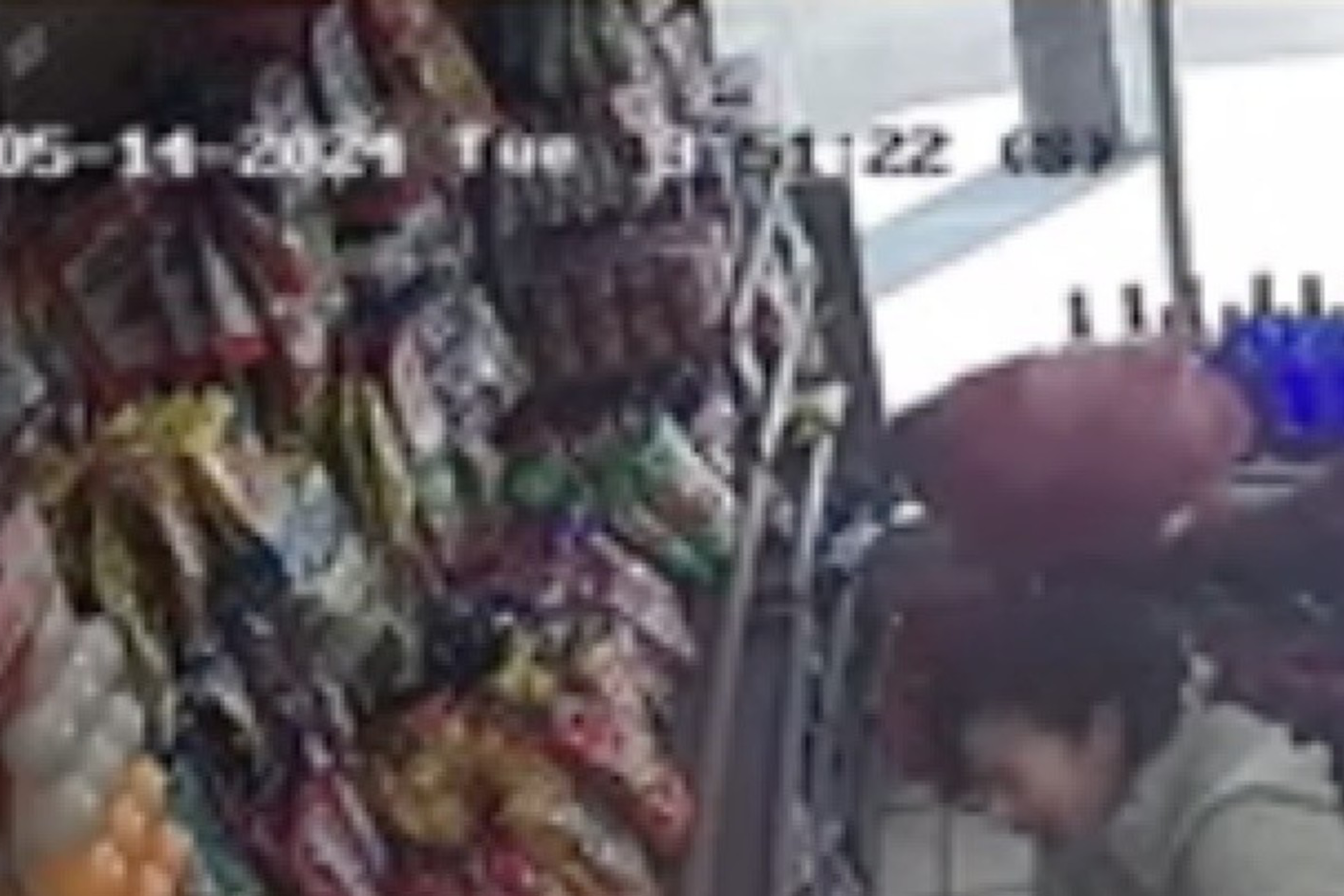 A still from surveillance video shows a woman being attacked by another woman inside a store.