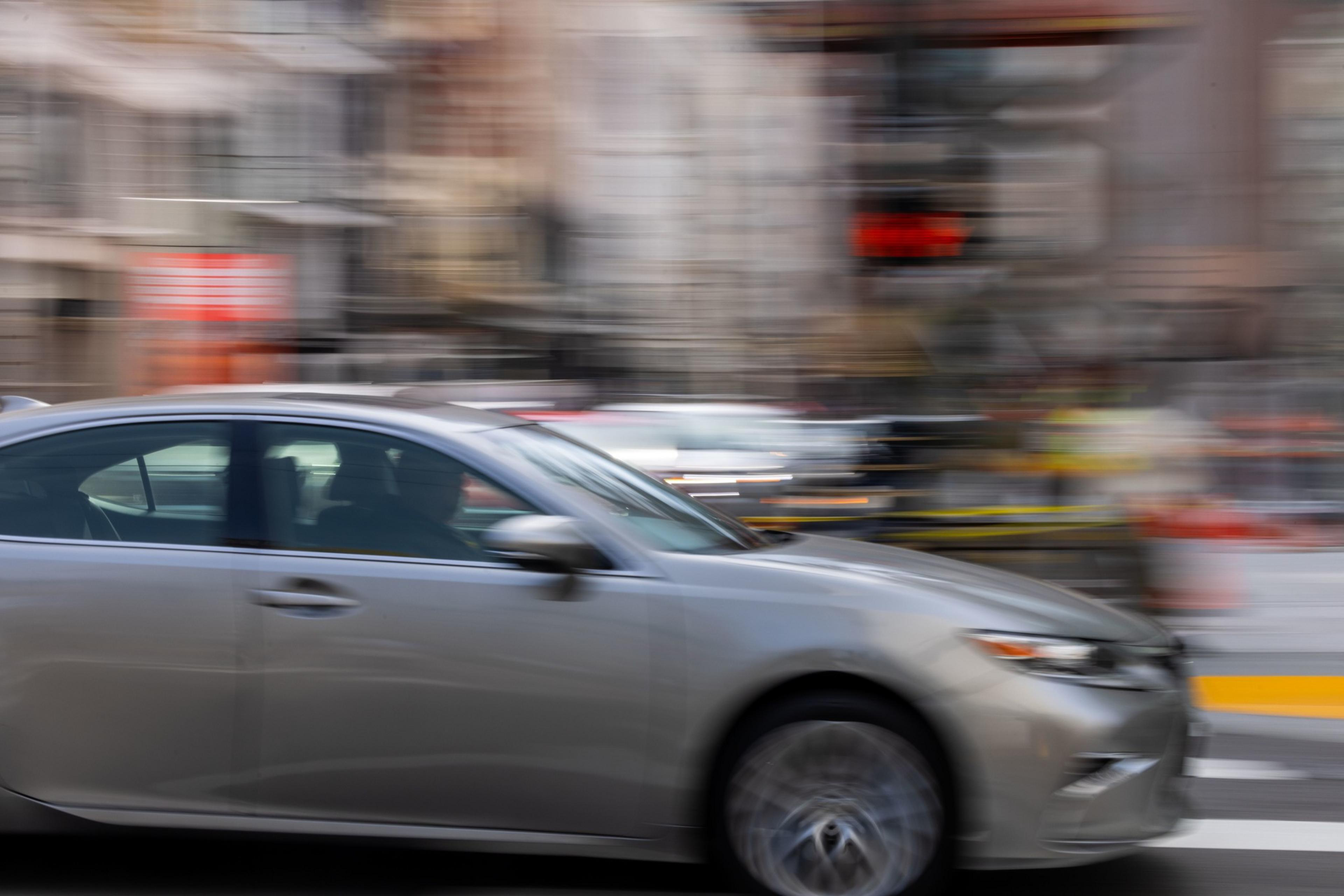 A photo of a silver car with a stylized blurry background.