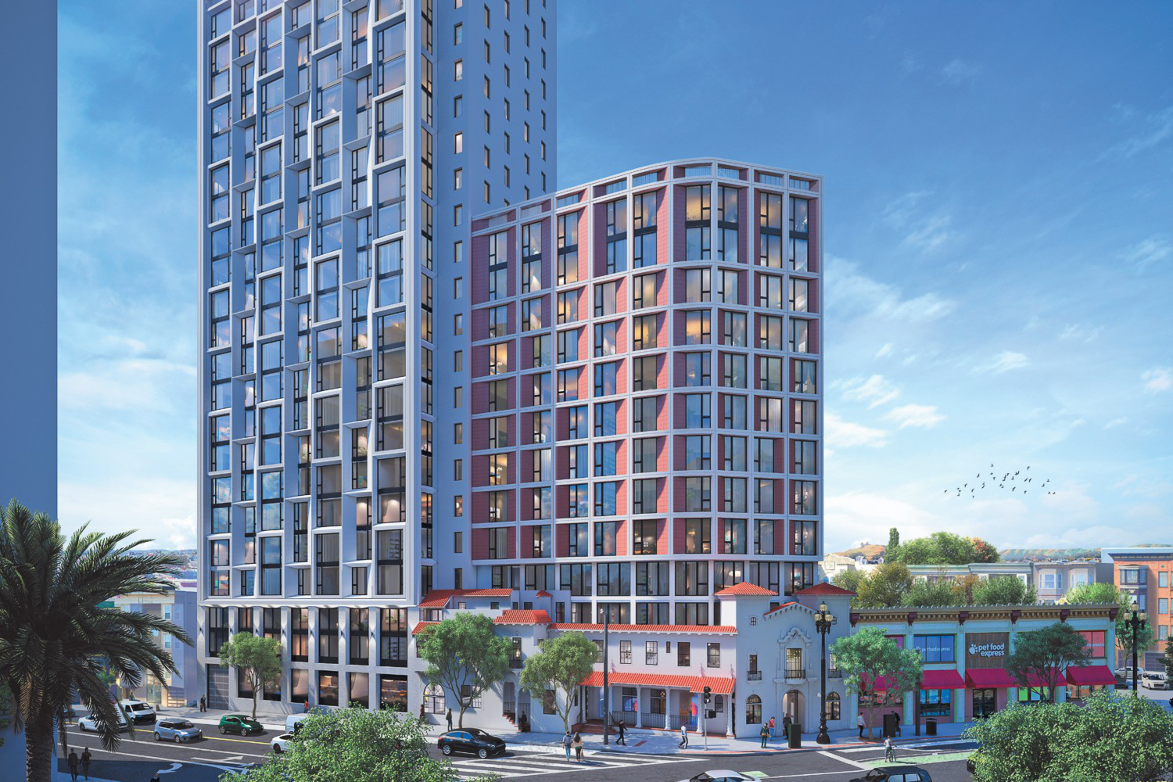 The image shows two modern, high-rise buildings with many windows, adjacent to a traditional, colorful low-rise structure on a busy street lined with trees and parked cars.