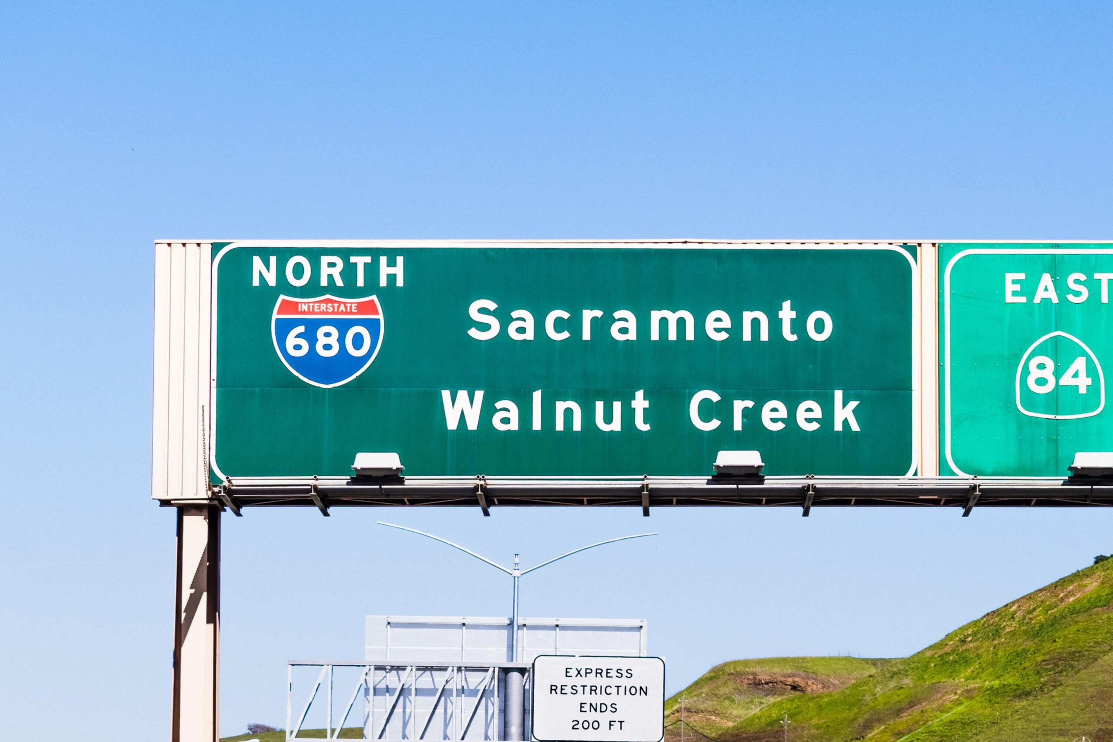 Highway signs indicate north Interstate 680 toward Sacramento and Walnut Creek, and east route 84, with express restriction ending in 200 feet.