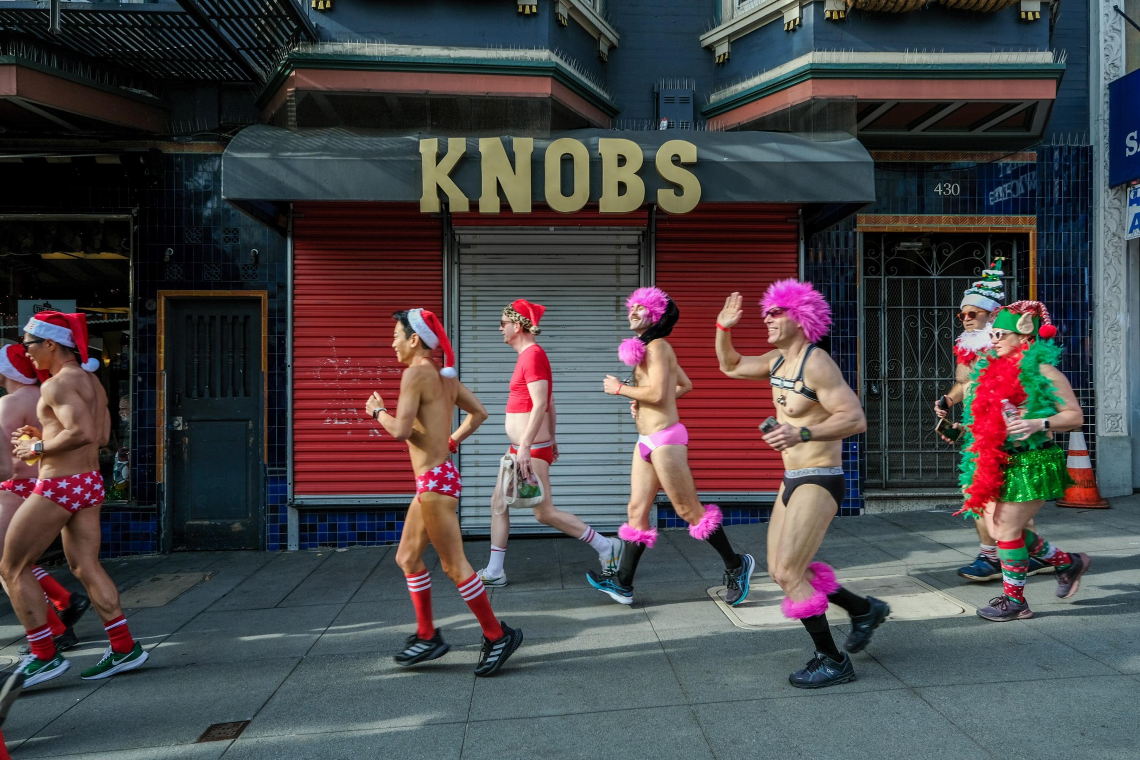 People dressed in underwear and Santa costumes rung across the street during a underwear fun run.