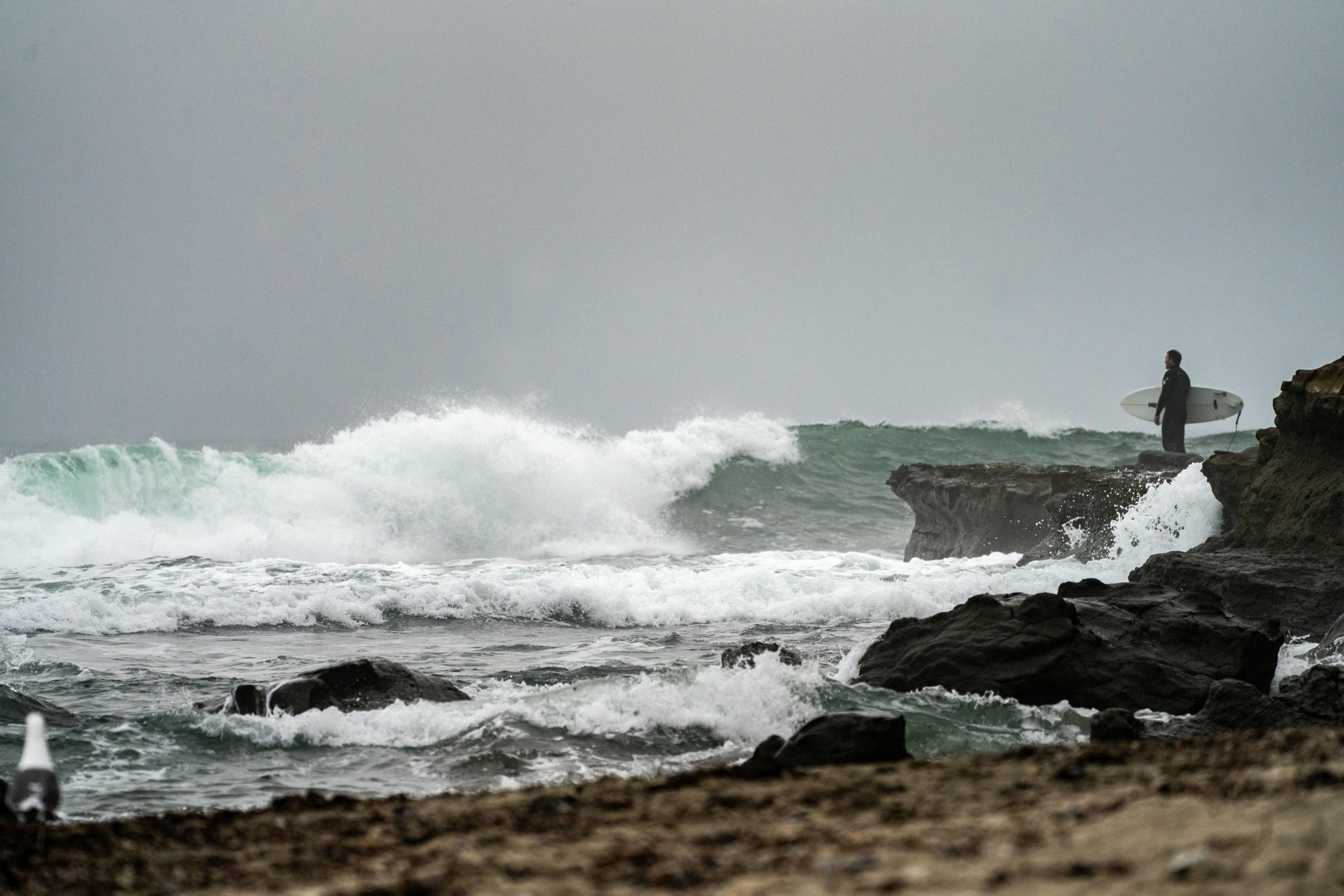 A wave crashes onto a beach