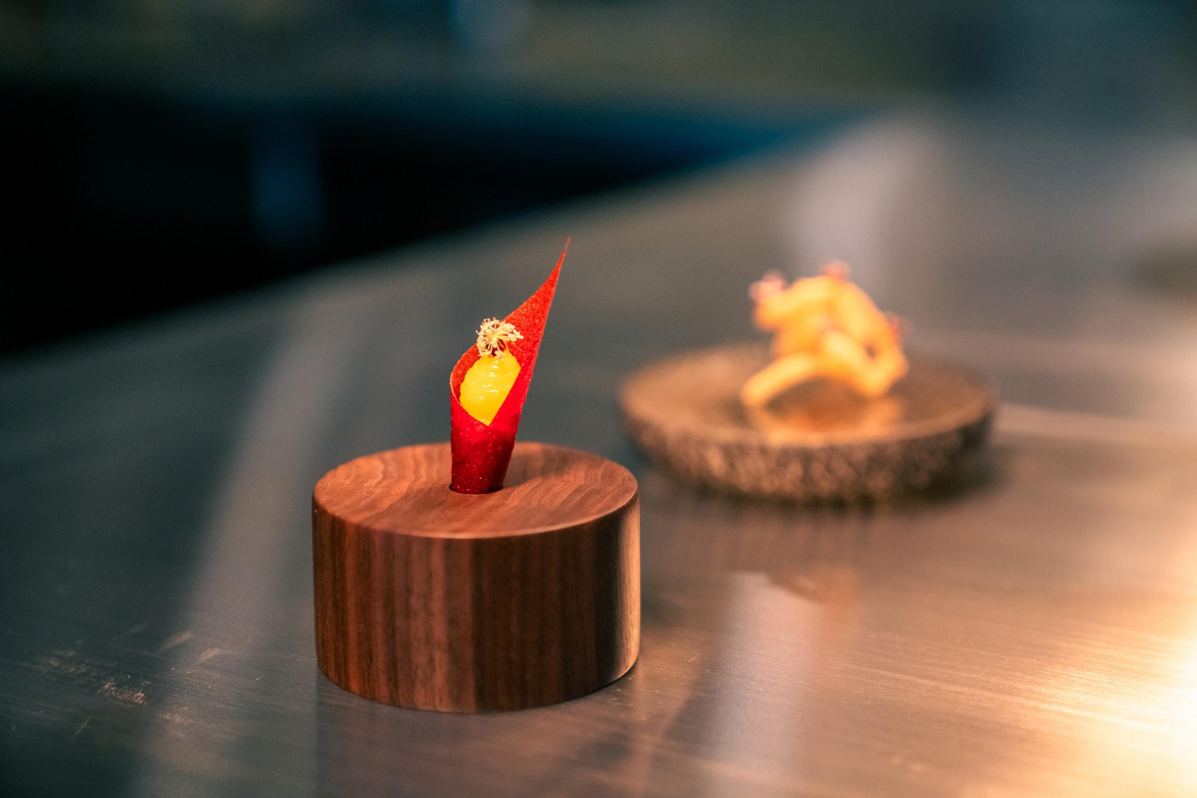 Two dishes are seen on display at Kiln.