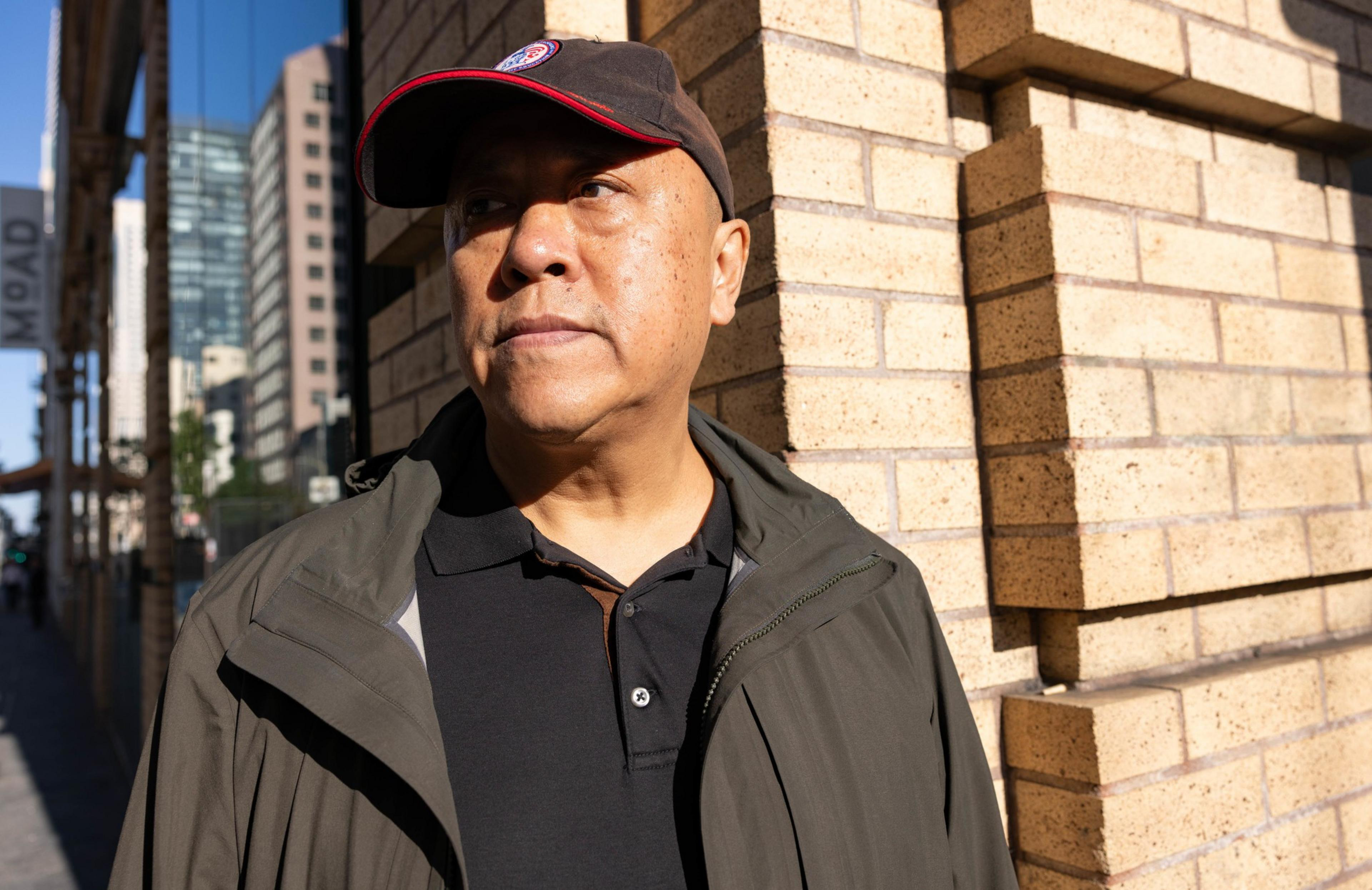 A man stands on a street corner.