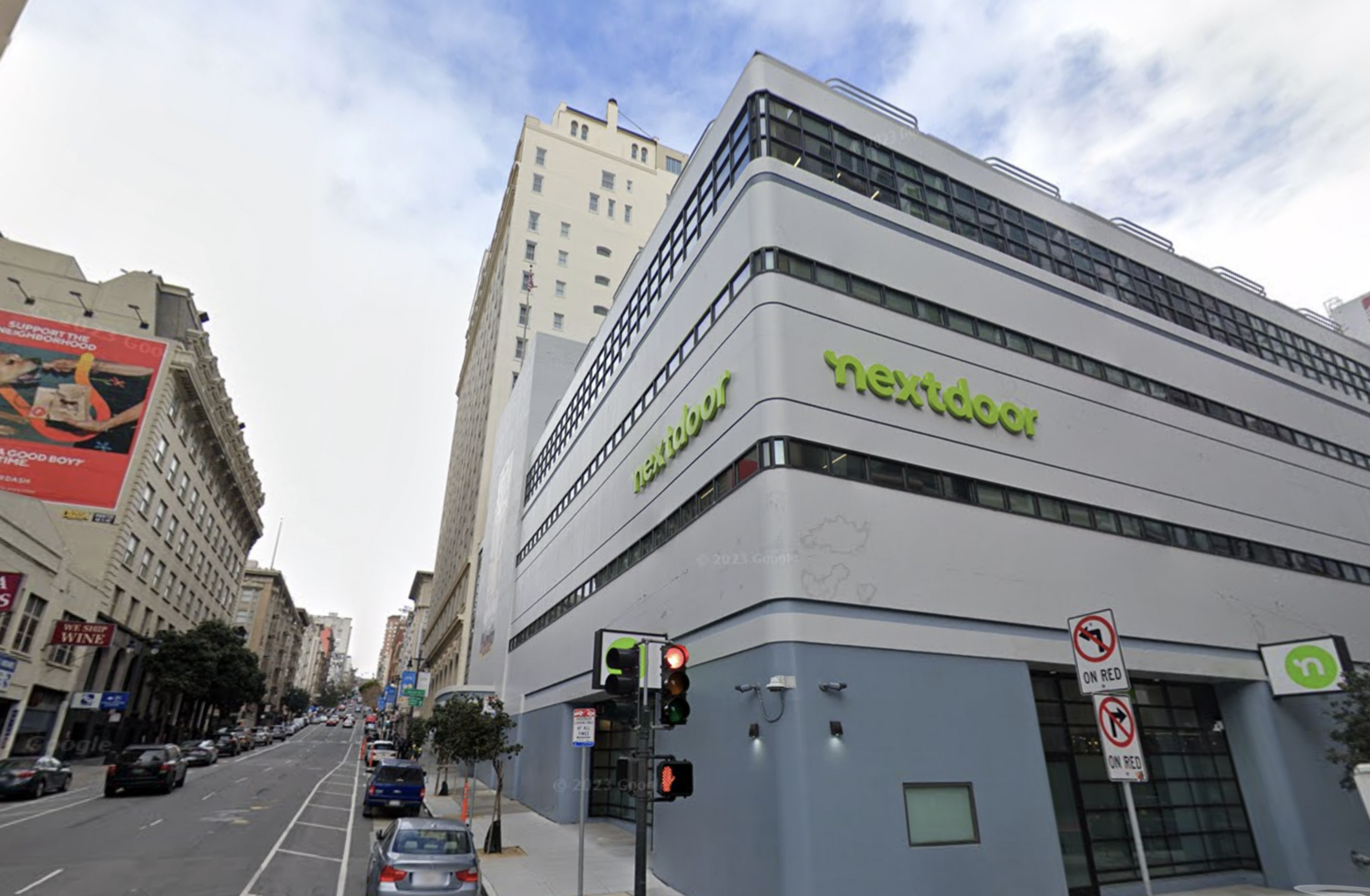The corner of a gray and blue building in San Francisco with Nextdoor's logo on two sides