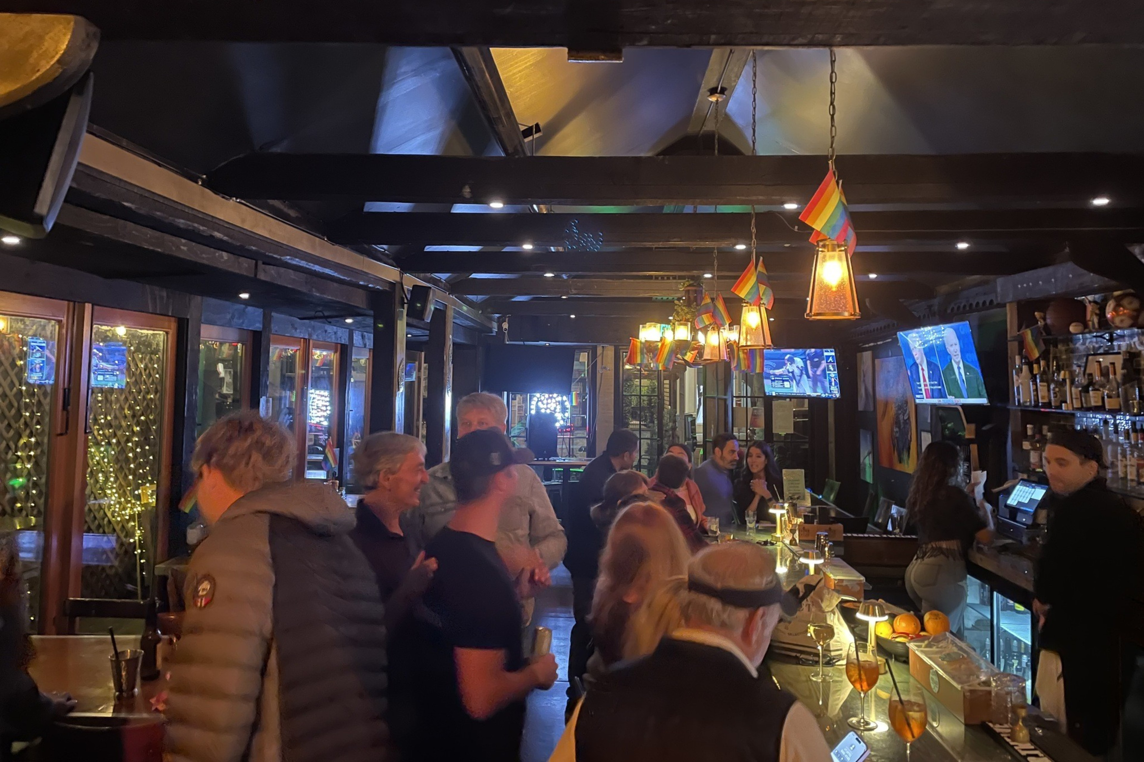 People mingle inside a bar.