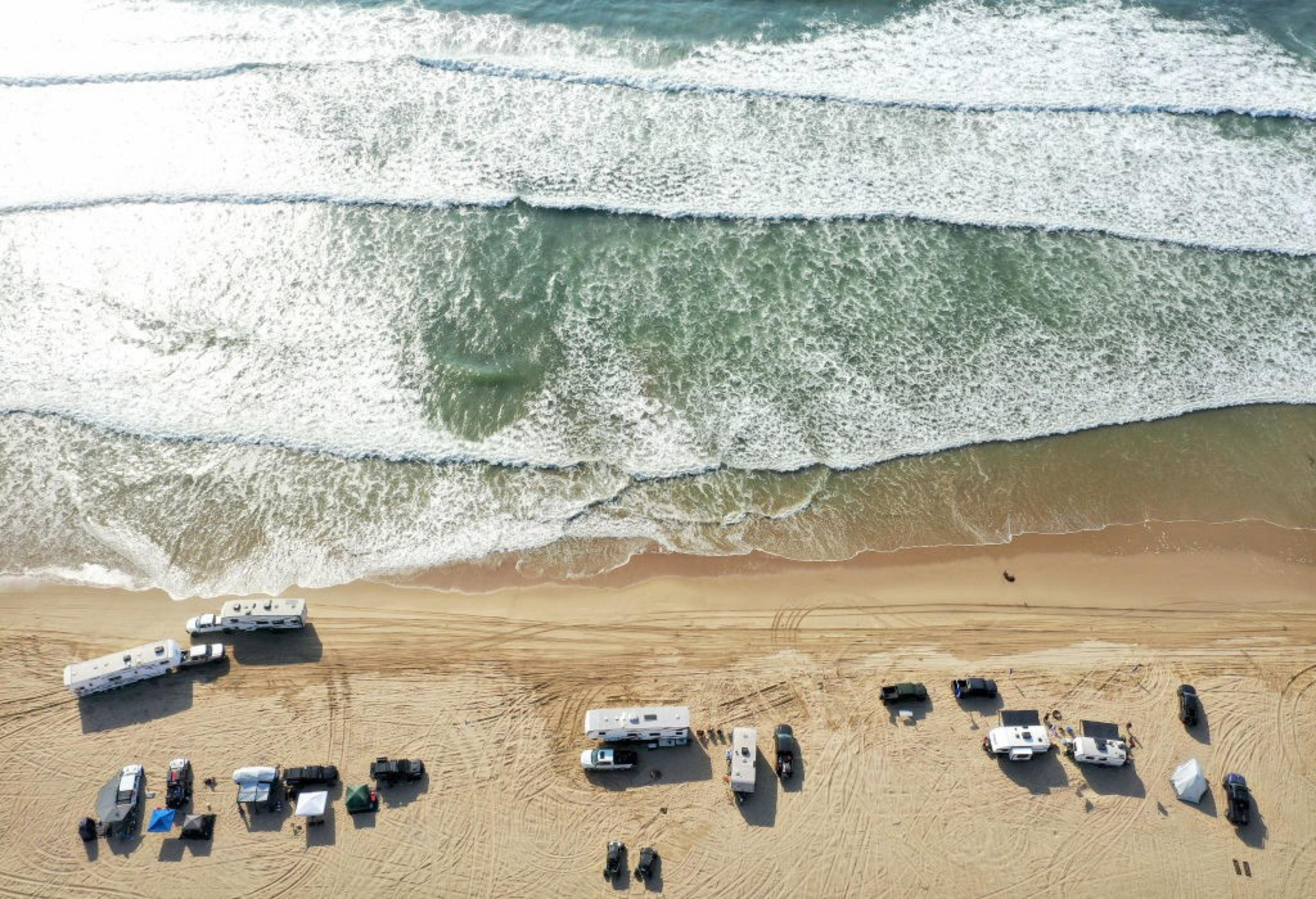 Wave seen from above crash into a beach