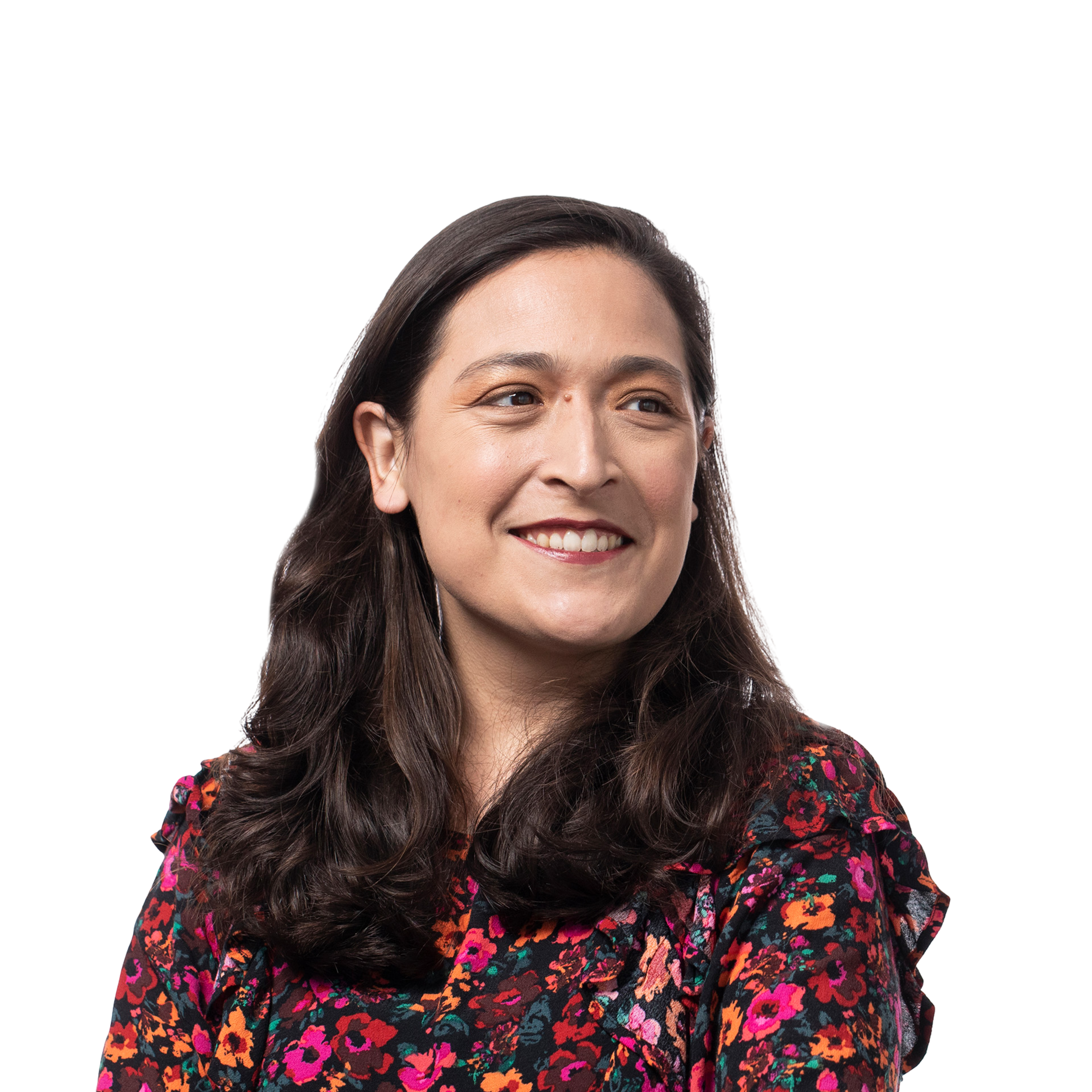 A woman with long dark hair smiles softly, wearing a dark floral blouse with bright orange, pink, and red flowers. She looks slightly to the side.