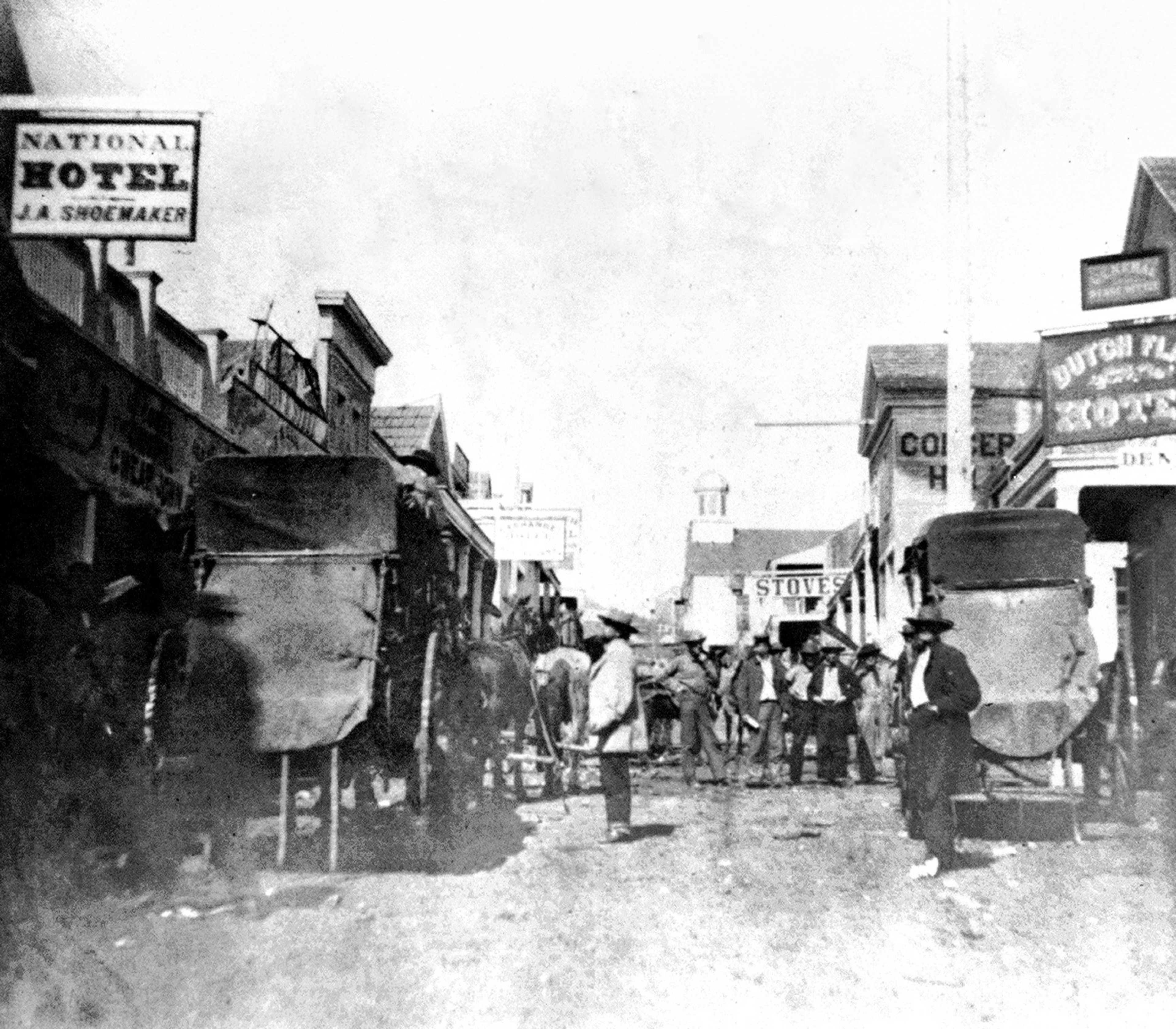 A black and white picture from 1866 with people and horses on the street.