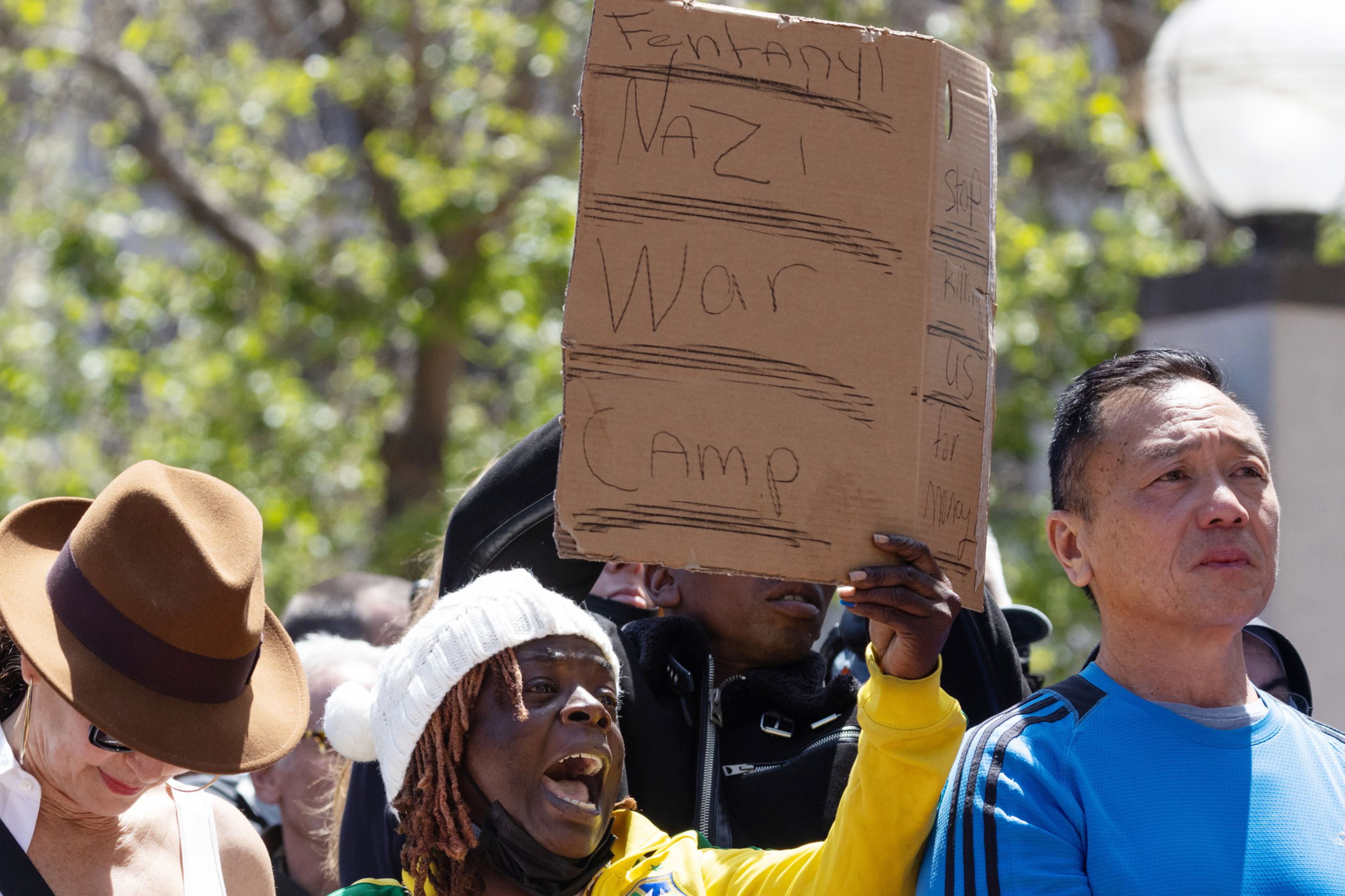People hold signs in UN Plaza