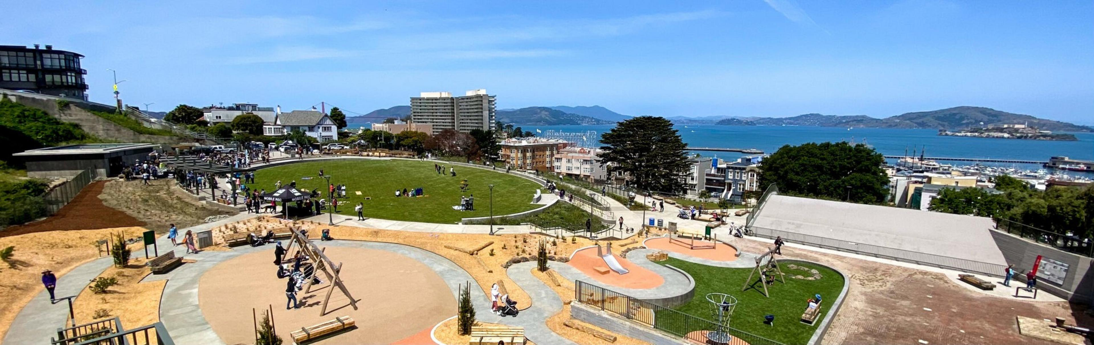 An aerial shot of a park with the SF Bay in the background.