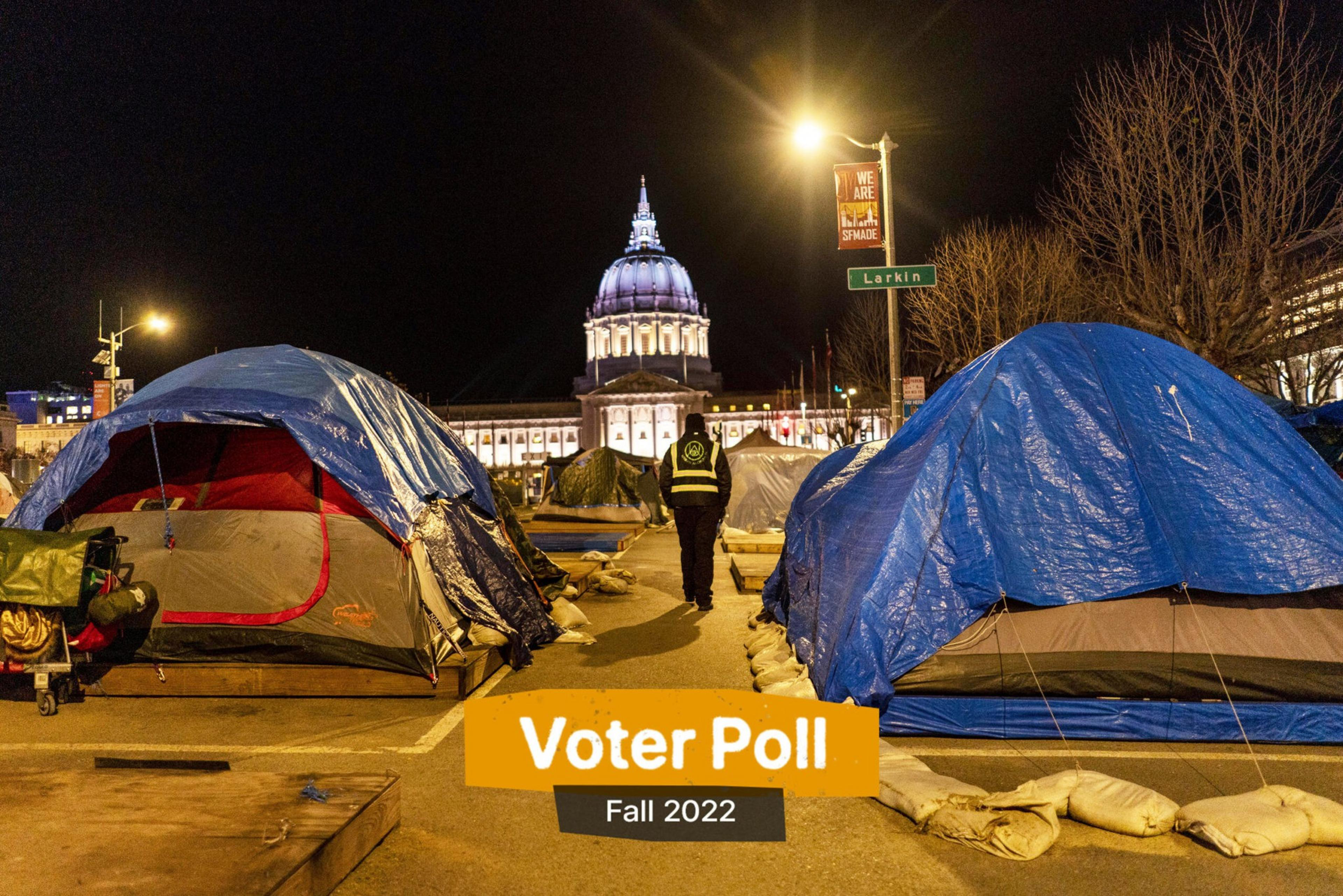Tents covered with tarps line a street at night near a lit government building, with a person walking away and a banner that reads "We Are The 99% In The Shade."