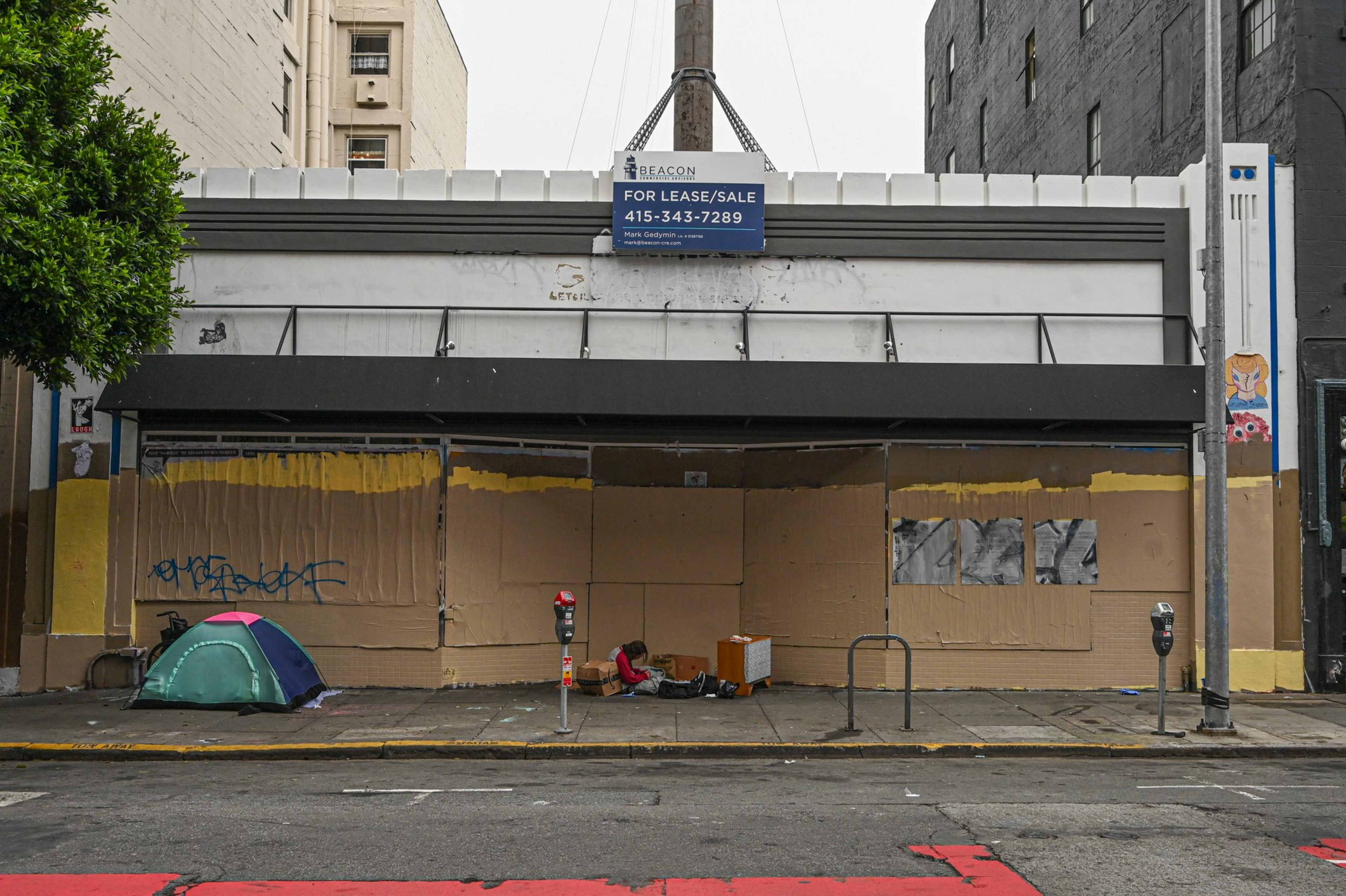 A decrepit building stands boarded up.