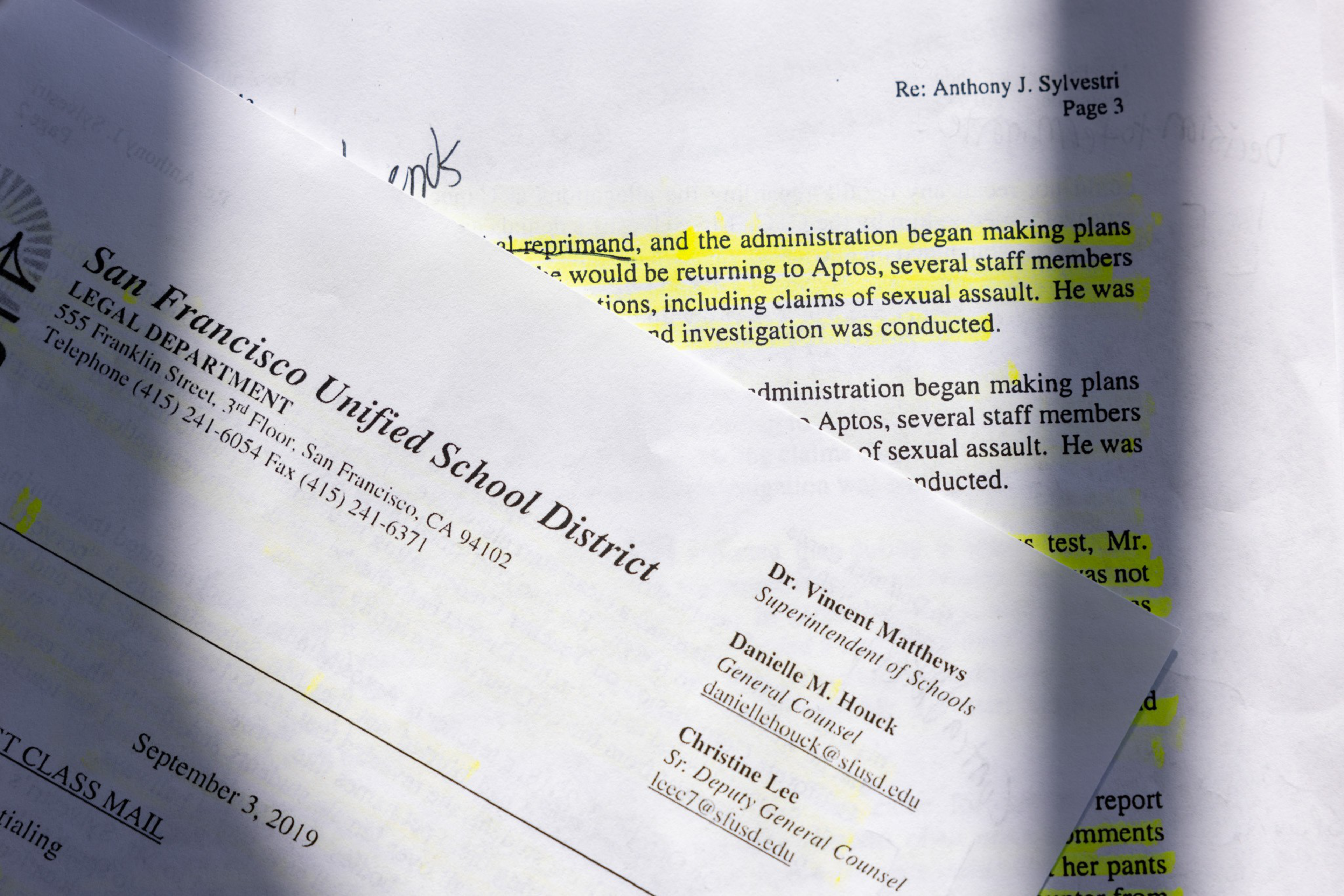 A partially folded letterhead from San Francisco Unified School District dated September 3, 2019, overlays a document with highlighted text about sexual assault claims.