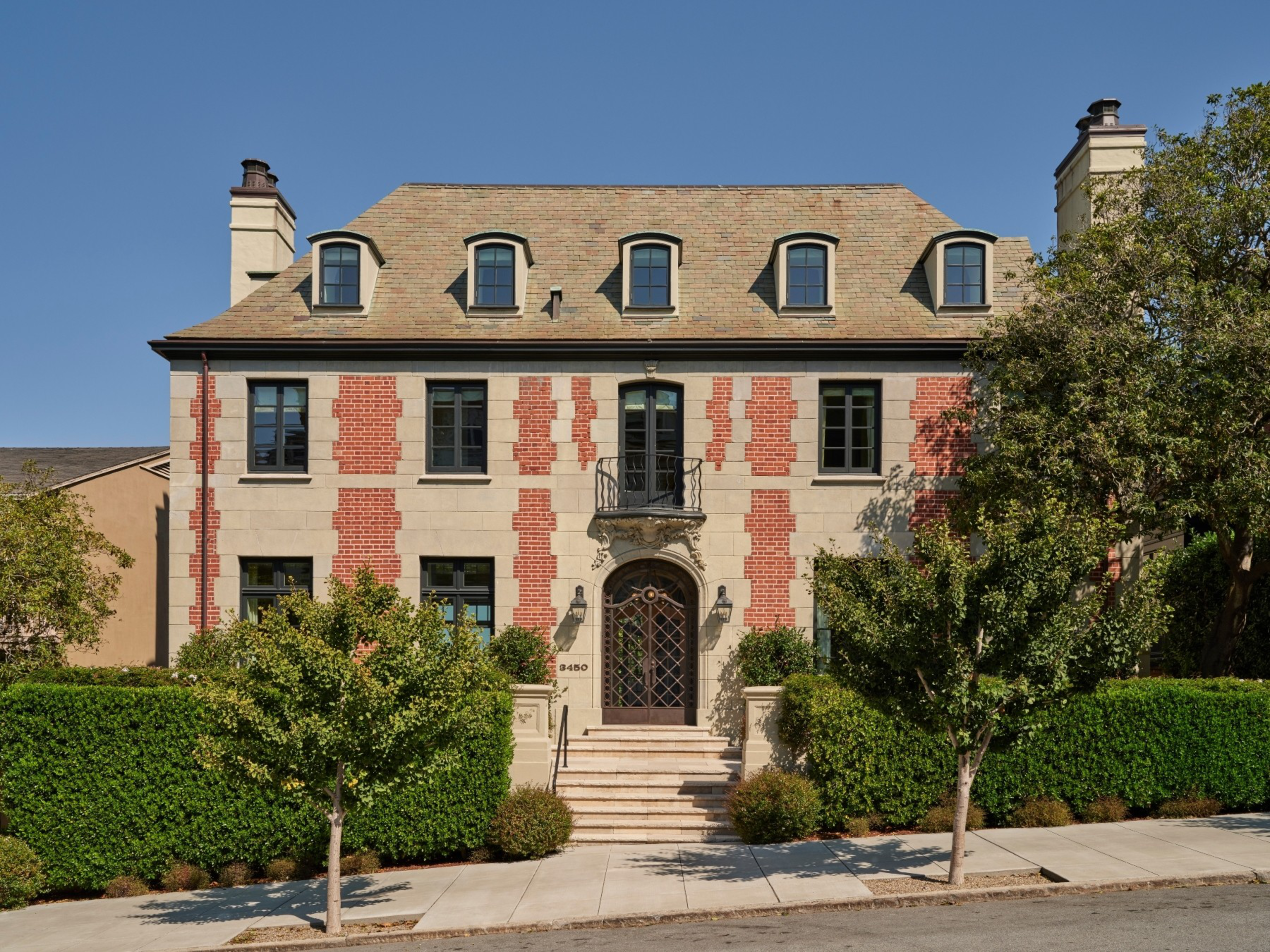 A mansion is seen from the front.