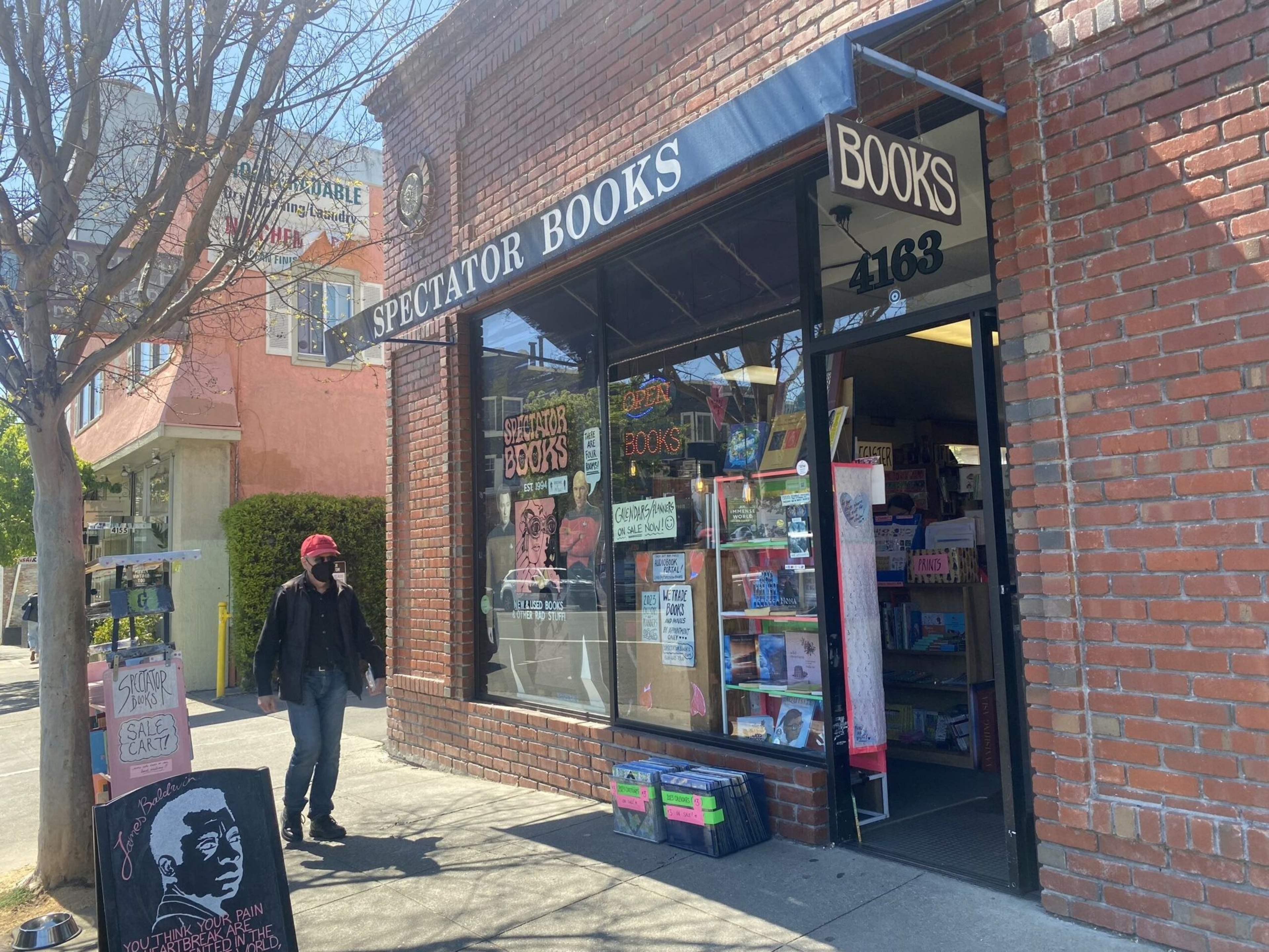 An red brick building with an awning for Spectator Books.