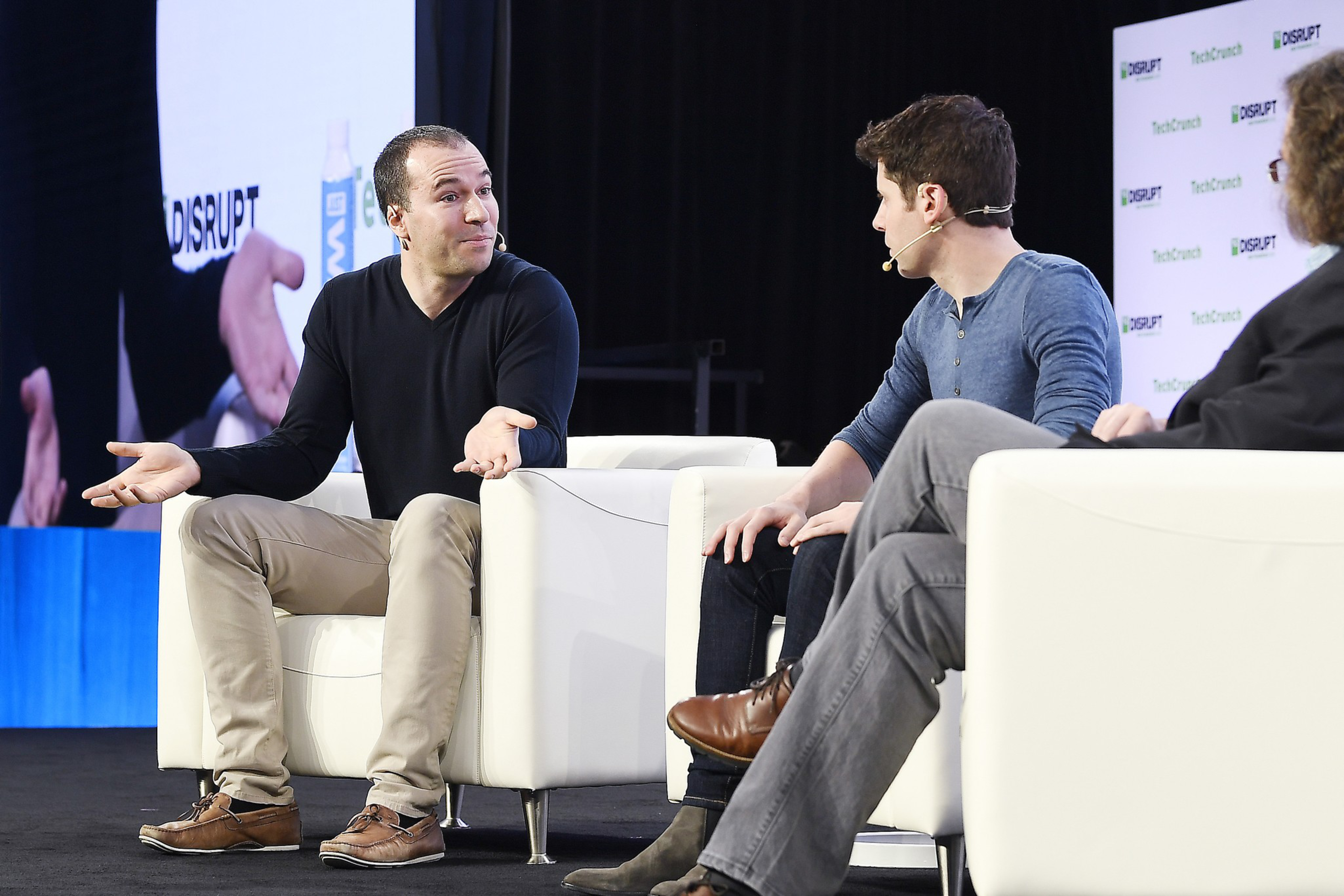3 men have a discussion on state during a symposium
